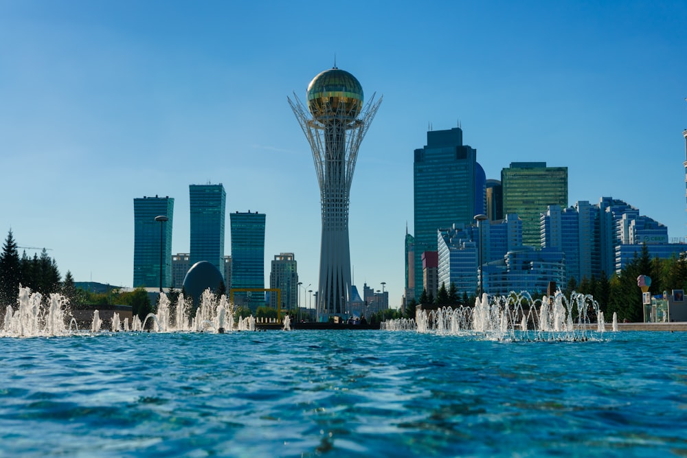 a city skyline with a fountain