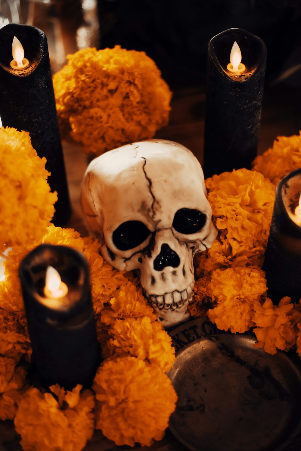 a skull with candles and flowers