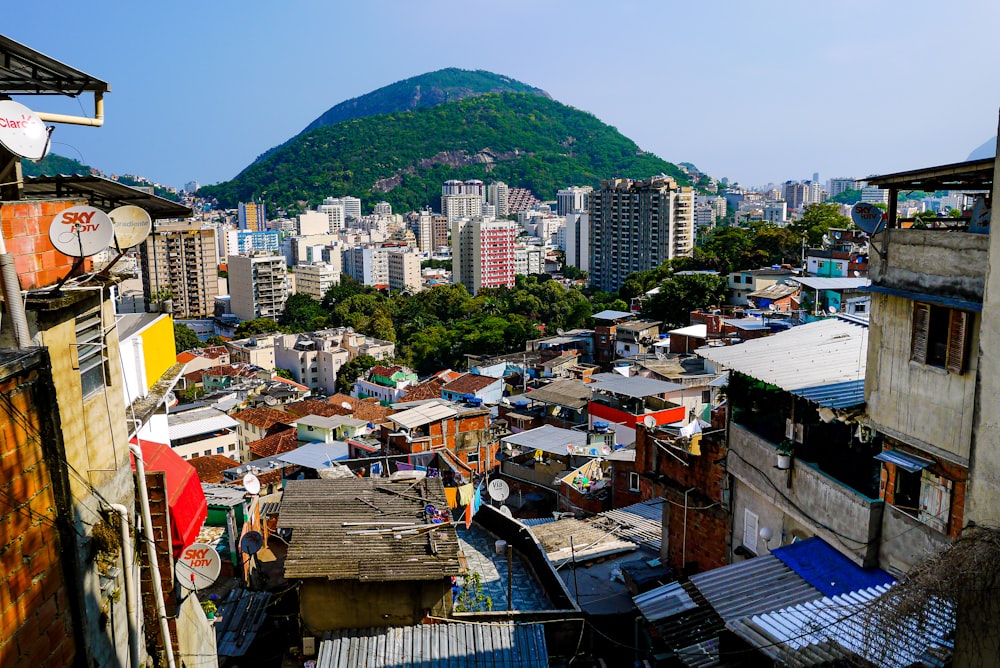 a city with many buildings and a hill in the background