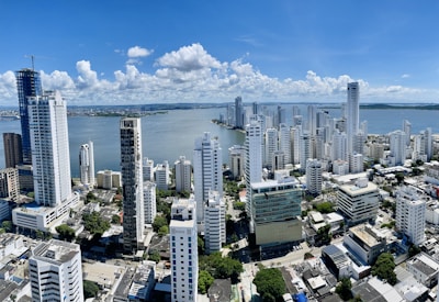 a city with tall buildings and a body of water in the background