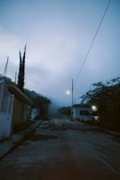 An eerie landscape at twilight, where shadows stretch across a deserted street.