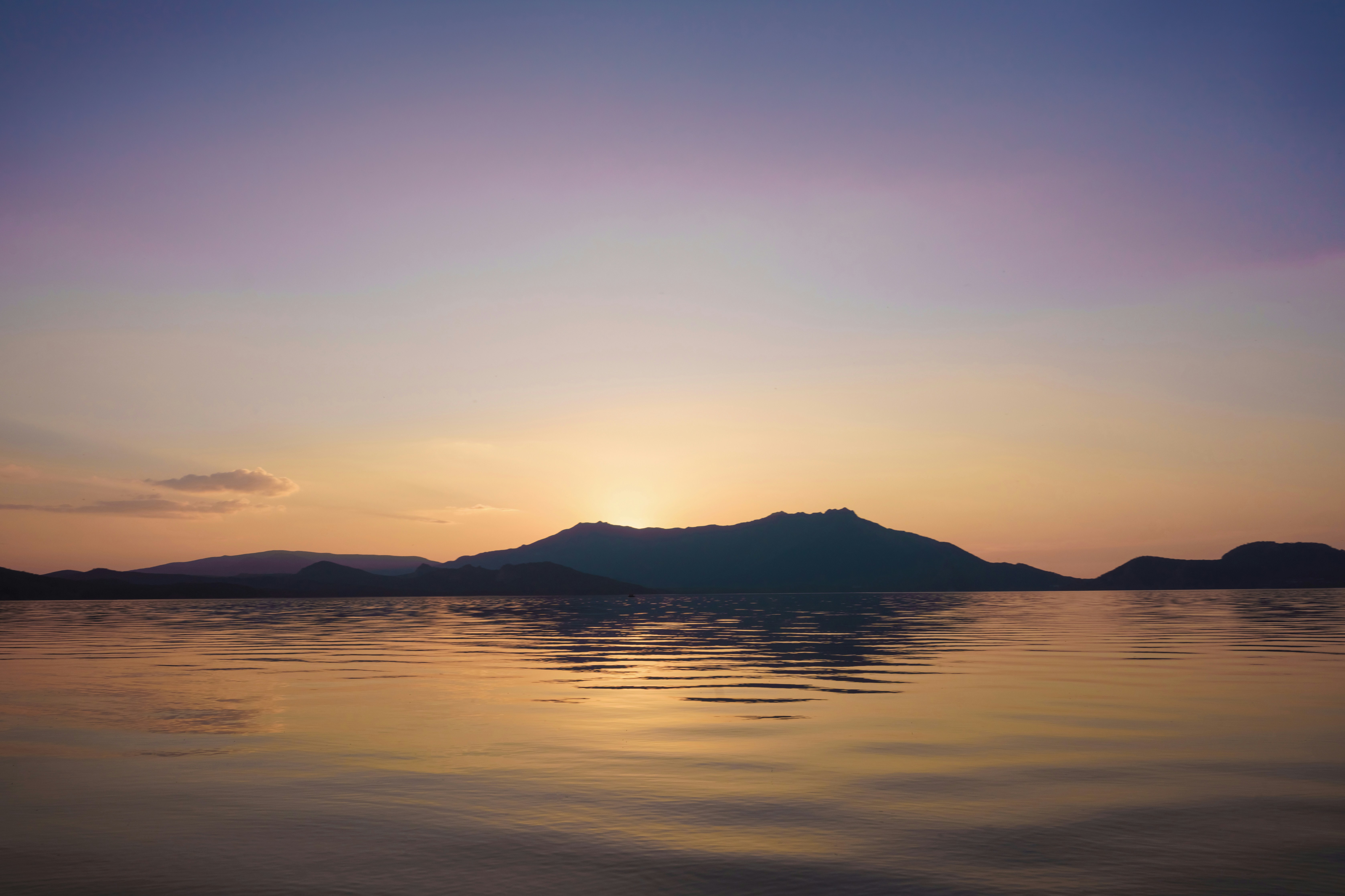 a body of water with hills in the background, Kazakhstan - August, 2022 - the lake