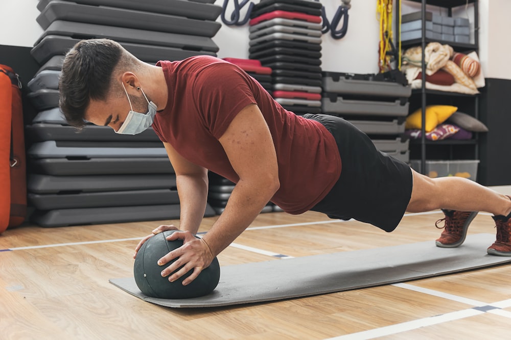 a man doing a plank on a gym floor