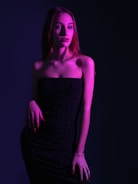 A stunning woman in an elegant dress, exuding confidence.