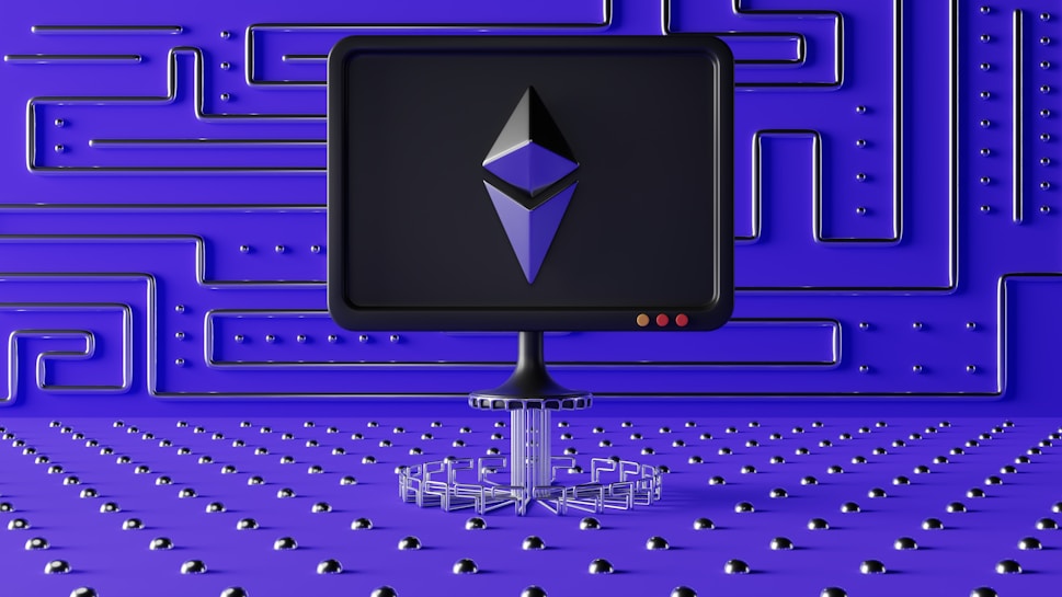 A dark computer screen displays a geometric shape resembling a logo, set against a futuristic blue wall with a maze-like pattern of raised lines and dots. The foreground features a base made of connected hexagons, adding to the high-tech aesthetic.