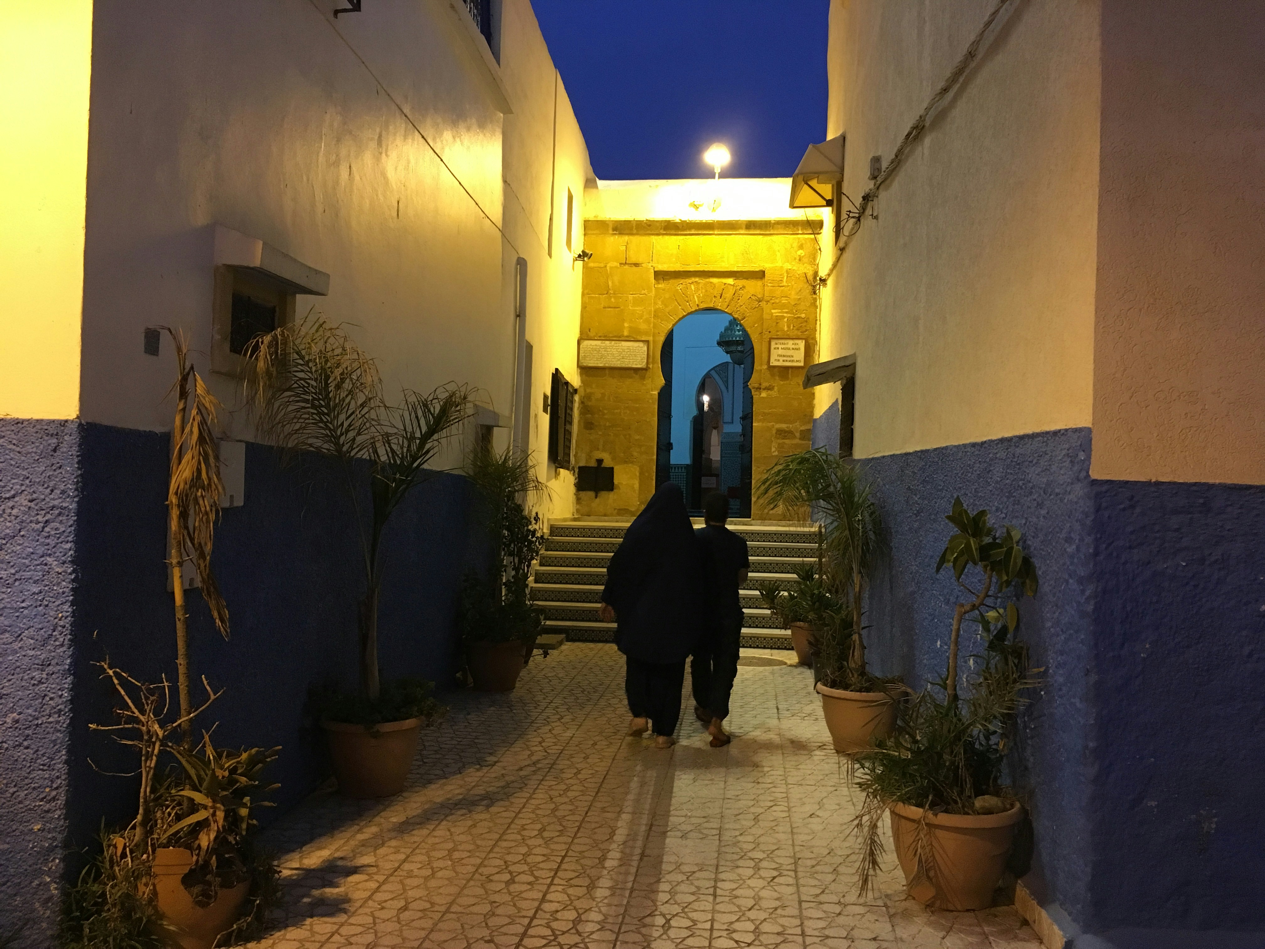a person walking down a stone street