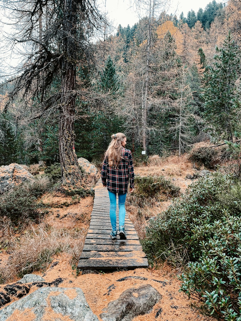 a person standing on a wooden bridge