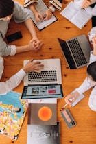 a group of people working on laptops
