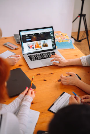 a group of people working on a laptop