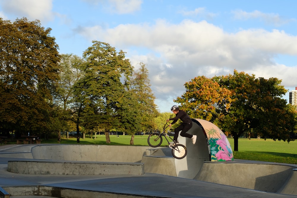 a person riding a bike on a concrete ramp