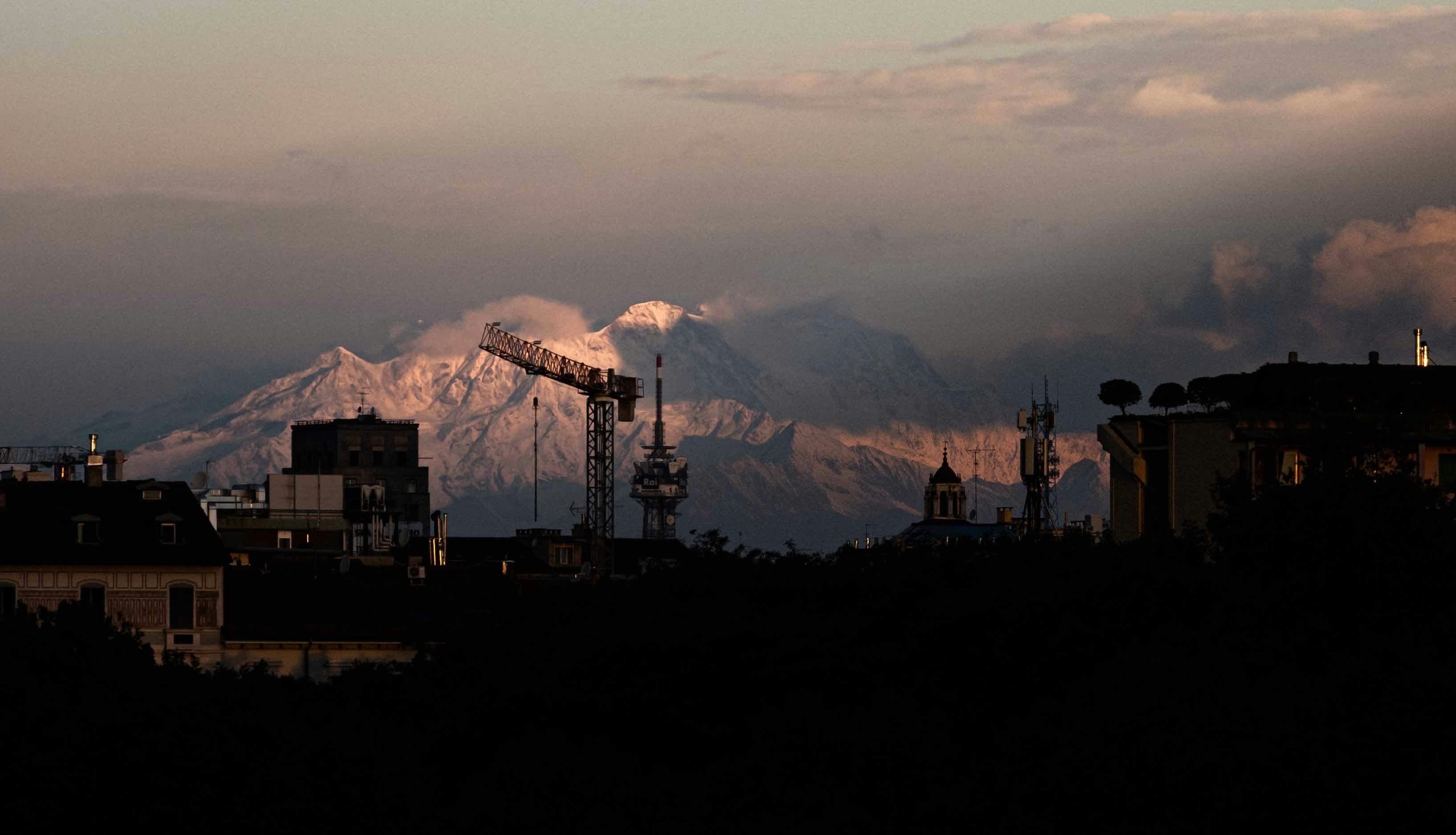 a crane in front of a mountain