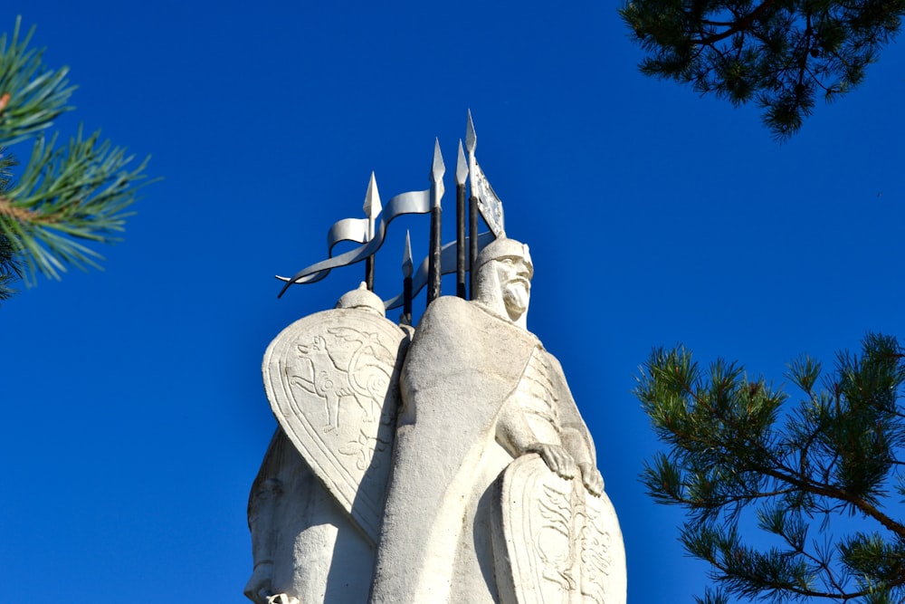 a statue of a person with a cross on top of it