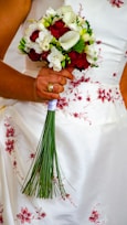 a just married holding a bouquet of flowers