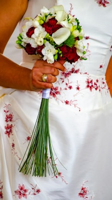 a just married holding a bouquet of flowers