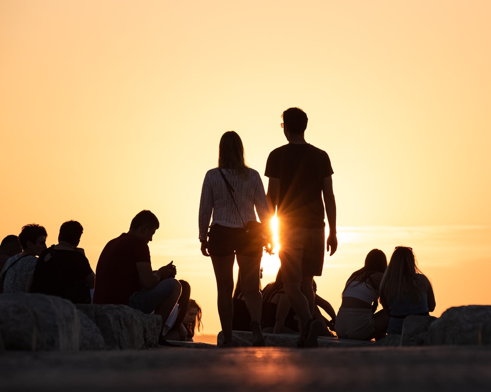 a group of people standing on top of a beach