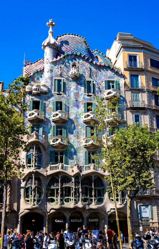 Casa Batllo's full curved, mosaic-covered facade with its skeletal balconies and dragon-scale roof