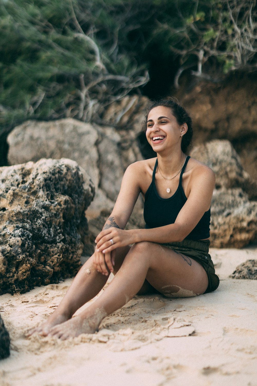 a woman sitting on a beach