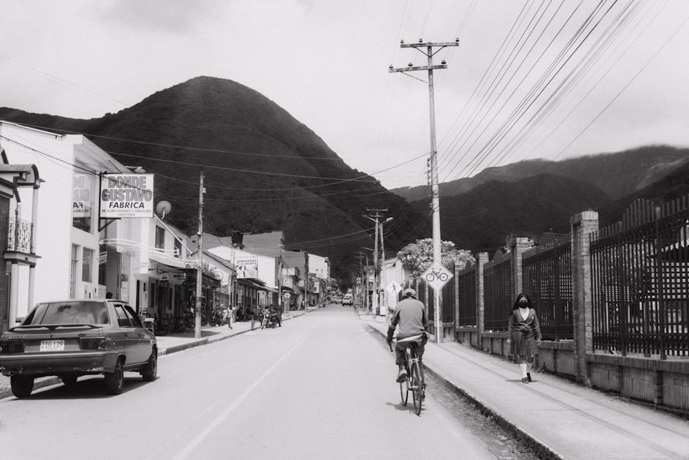 a man riding a bicycle down a street