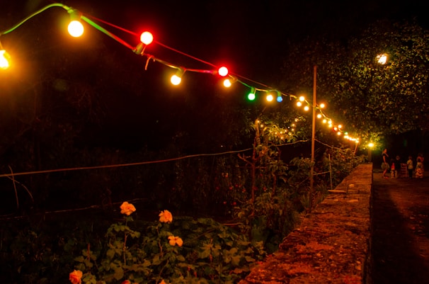 Multi-color solar lights casting a gentle glow along a patio pathway.
