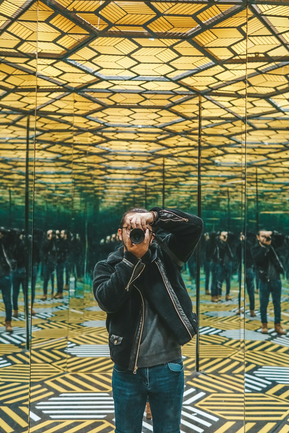 a person taking a picture of a large glass ceiling