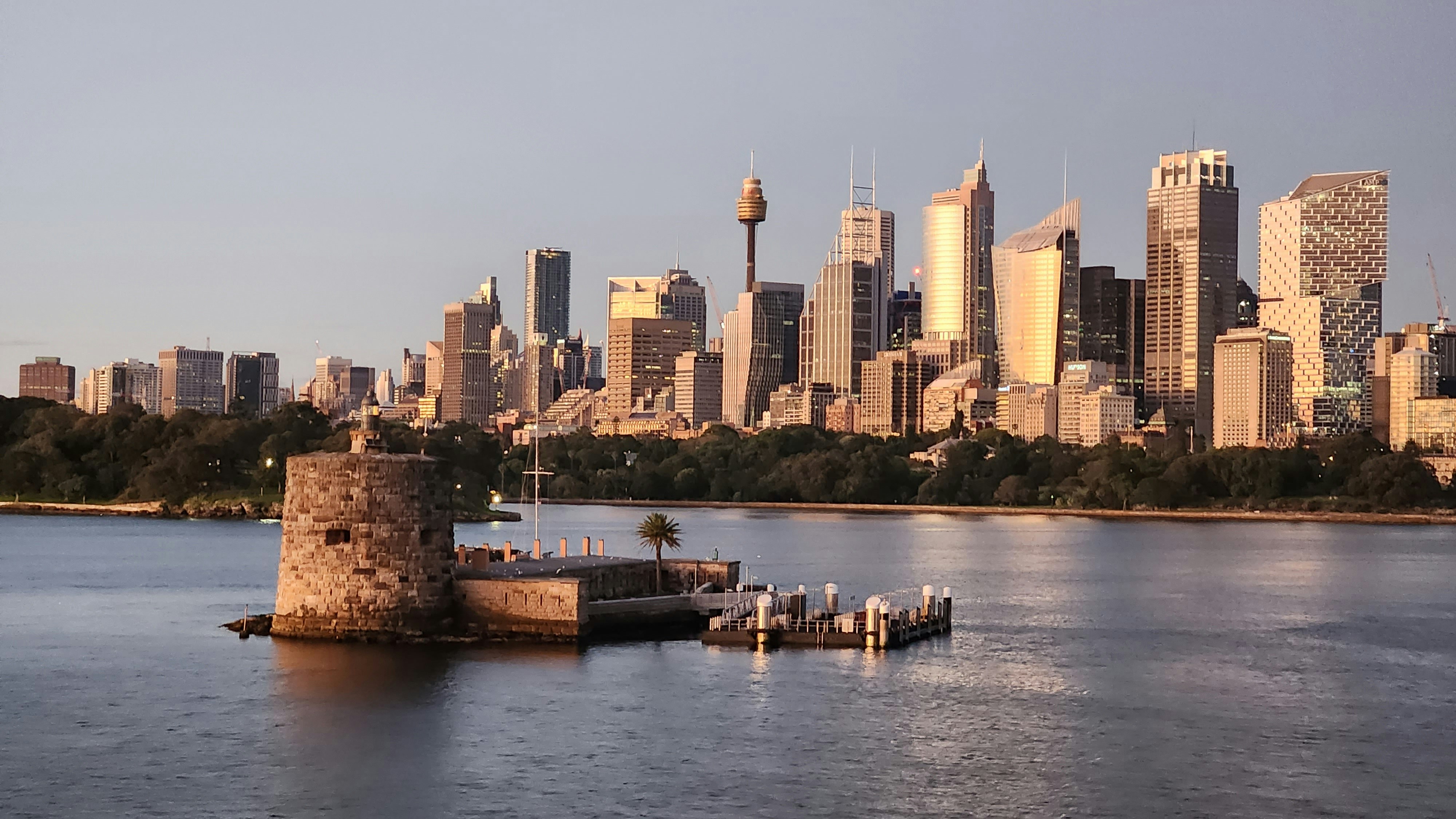 a city skyline with a body of water in front of it
