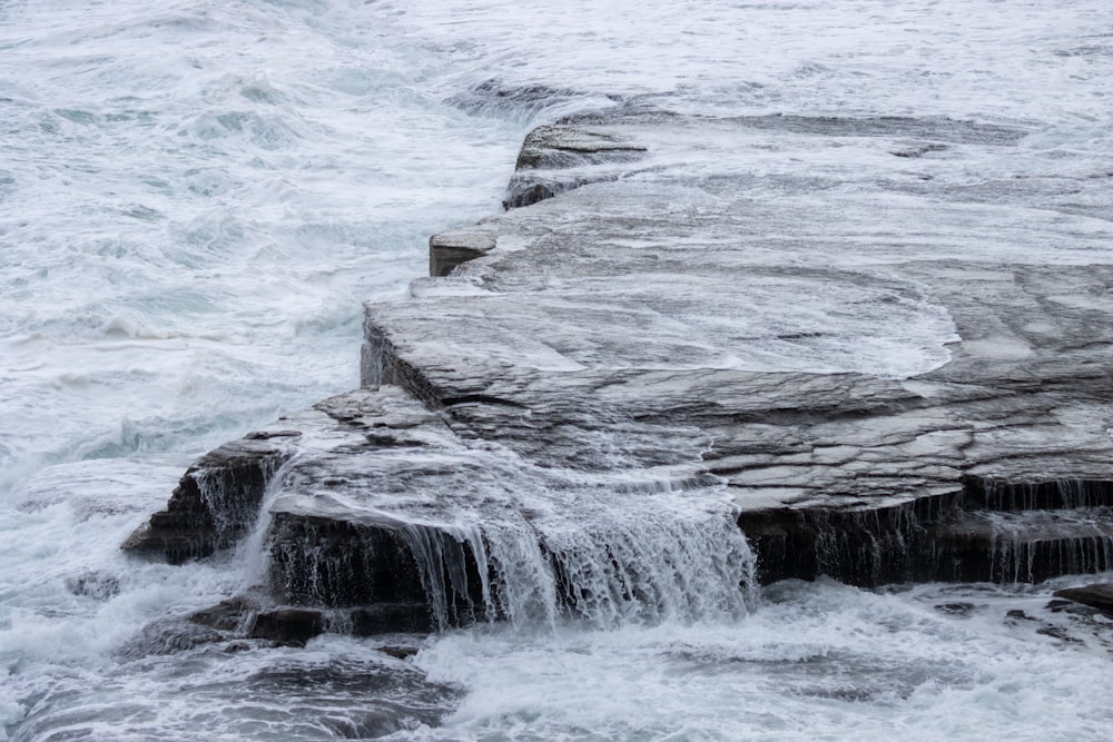 a large rock formation in the ocean