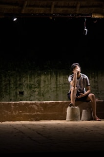 a person sitting on a ledge