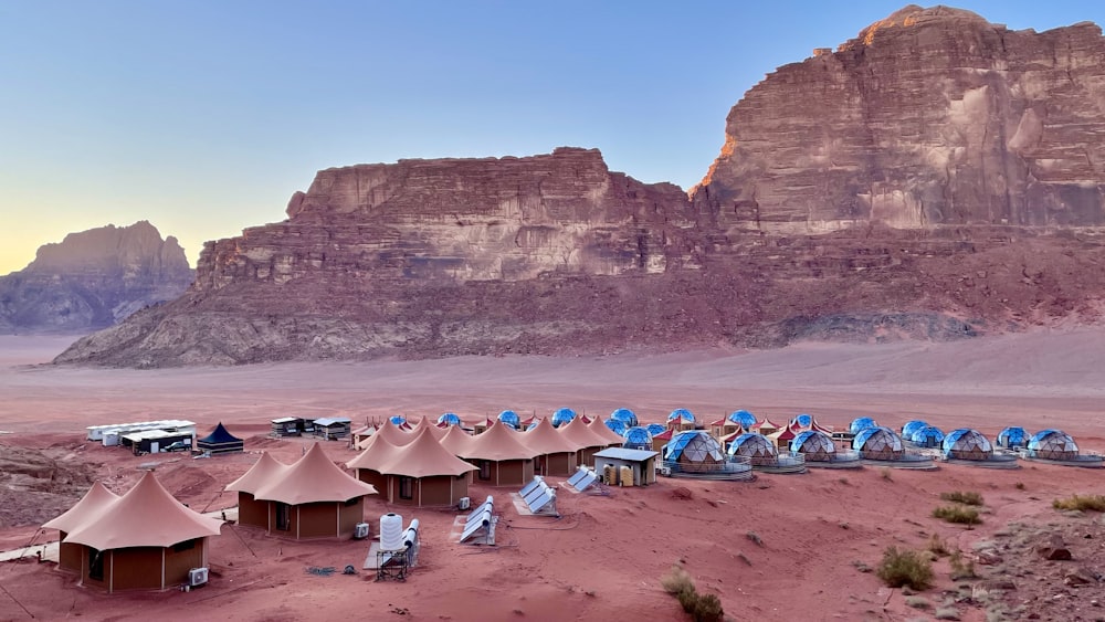 a desert with tents and mountains