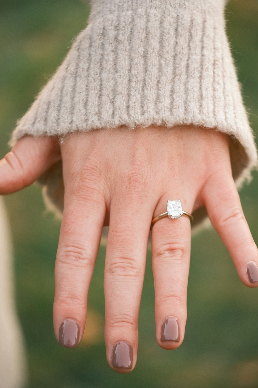 a person's hand with a ring on it