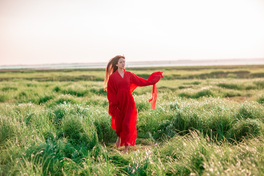 a person in a red dress in a field