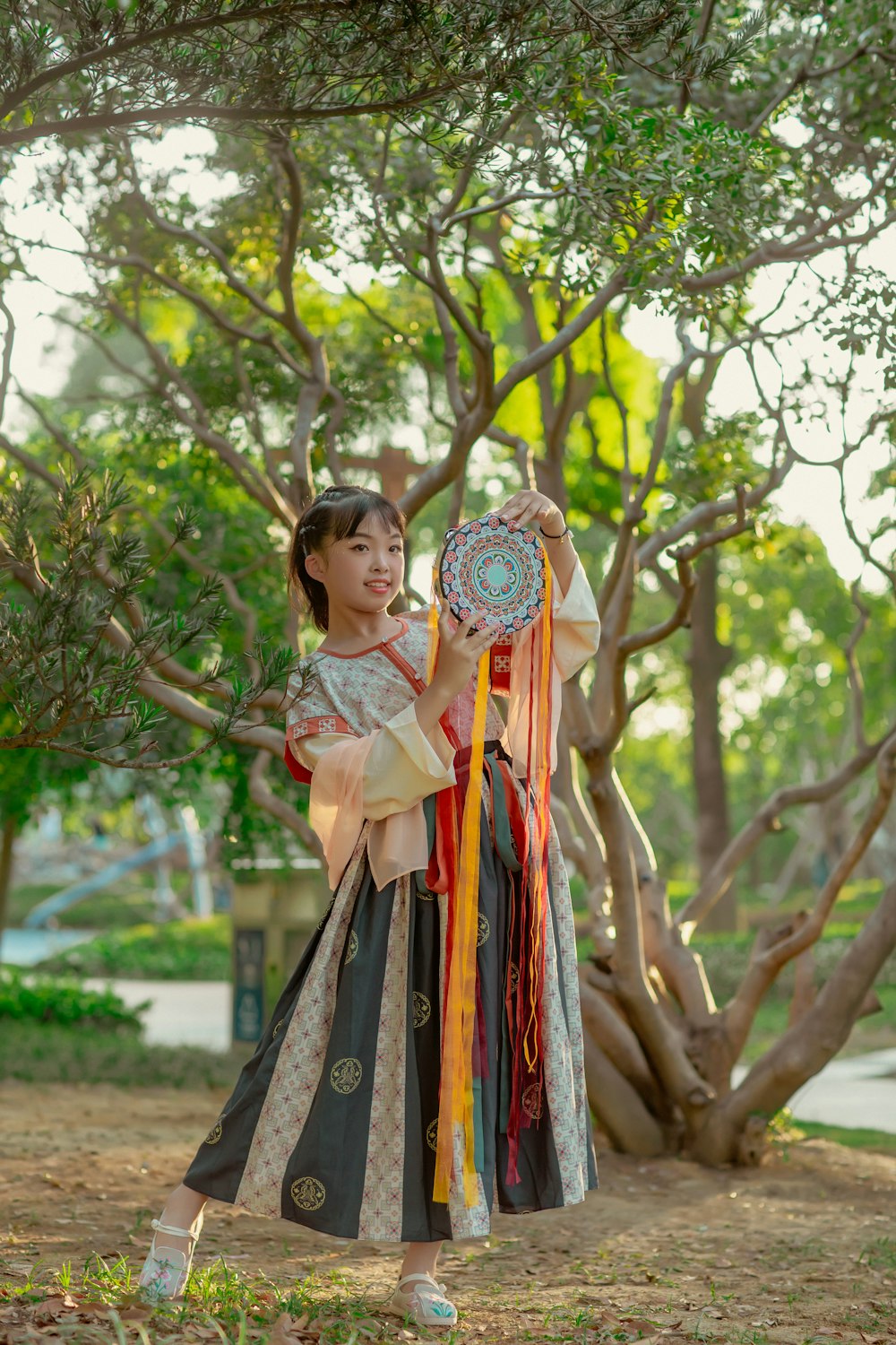 a person in a traditional dress holding a tree branch