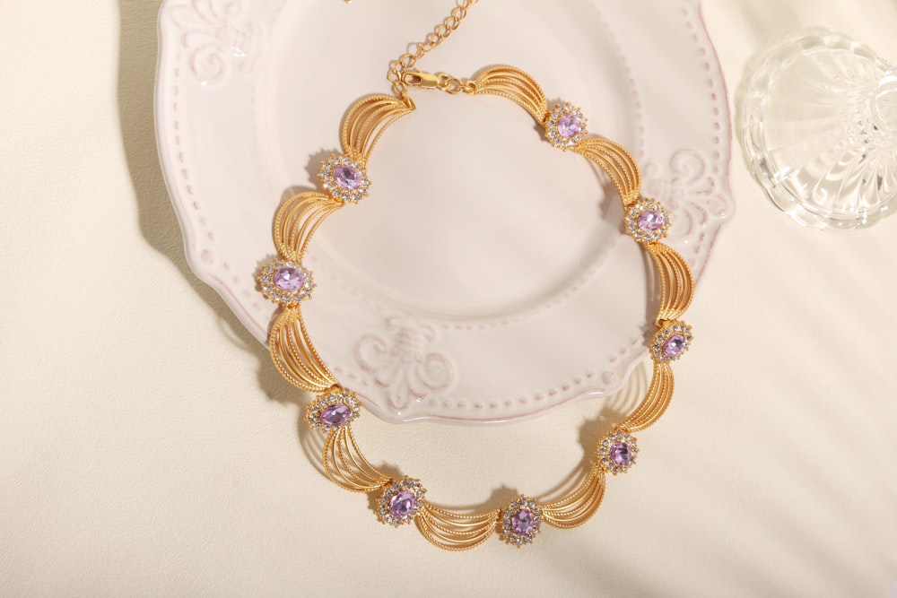 a gold necklace with a diamond