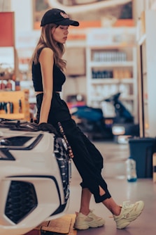 a woman sitting on a car