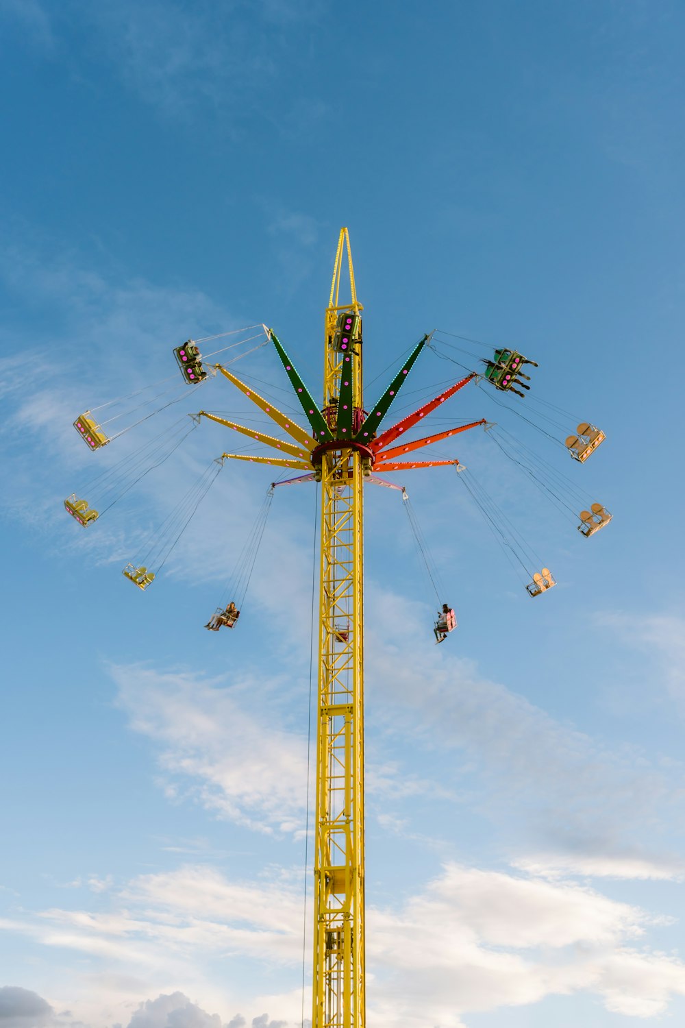 a tall tower with many kites flying in the sky