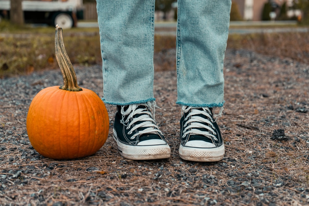 a pumpkin and shoes on the ground