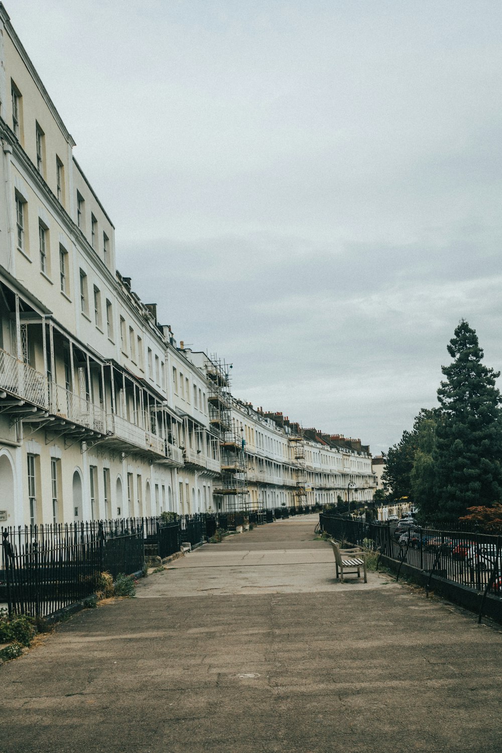 a path with benches and buildings on either side of it