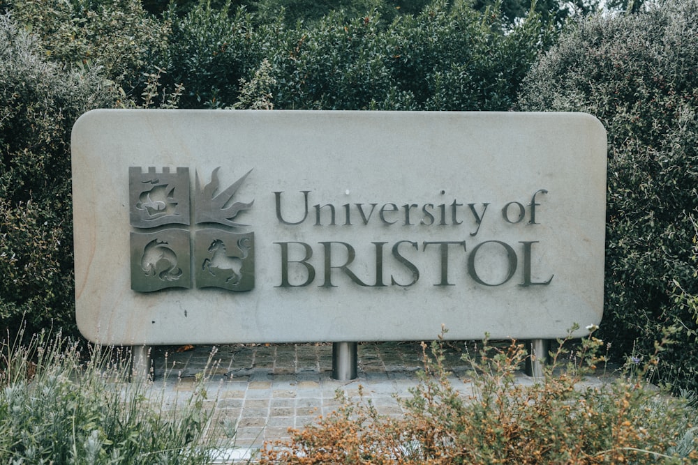 a sign in front of bushes