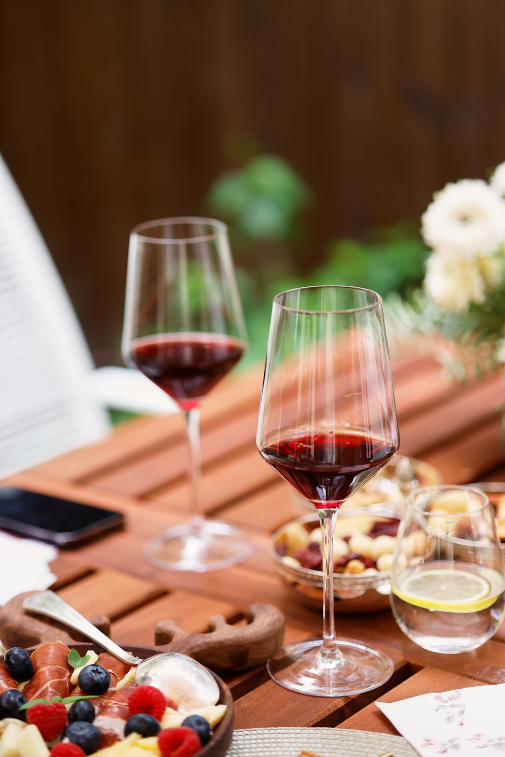 a group of wine glasses with red wine in them