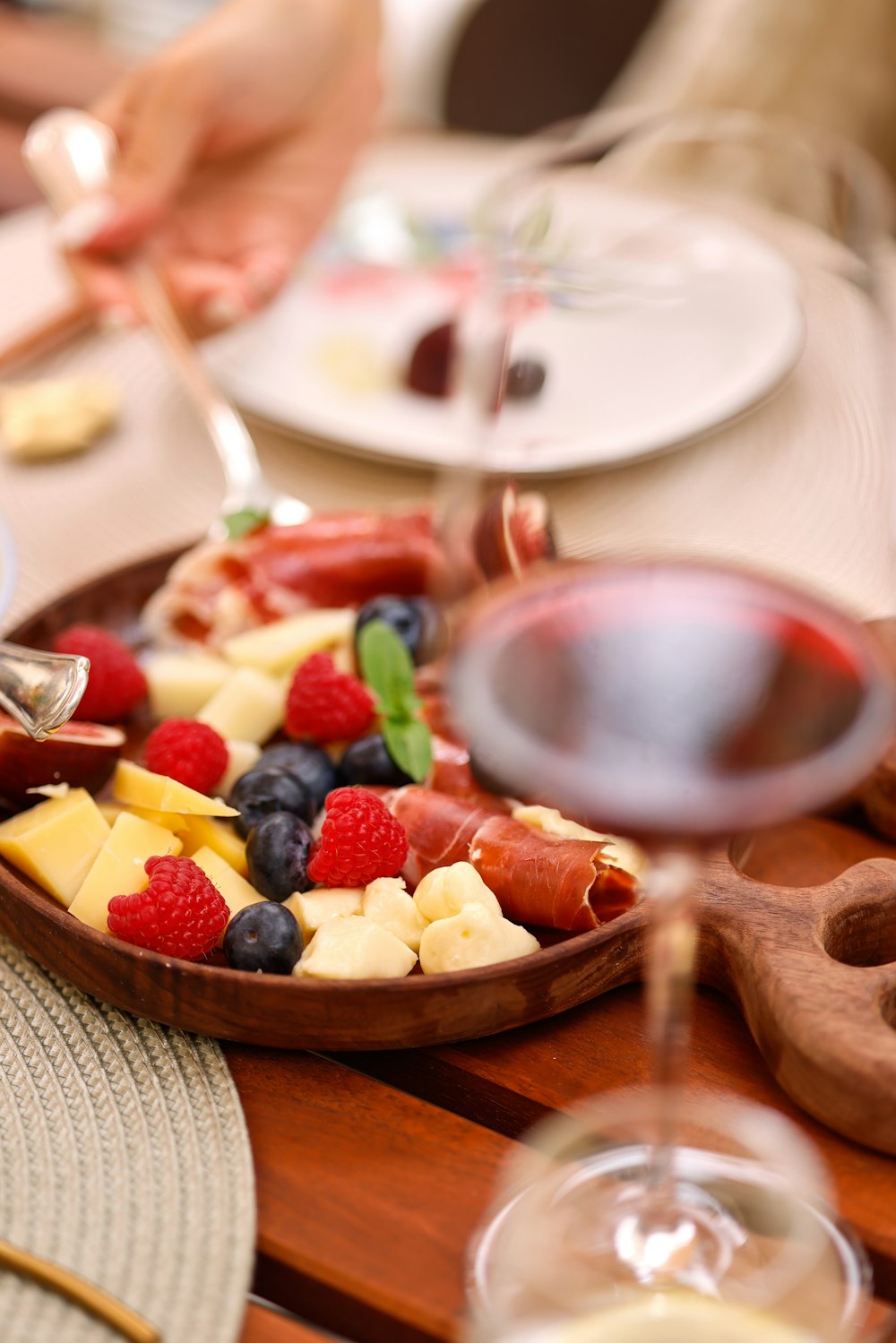 a bowl of fruit and a glass of wine