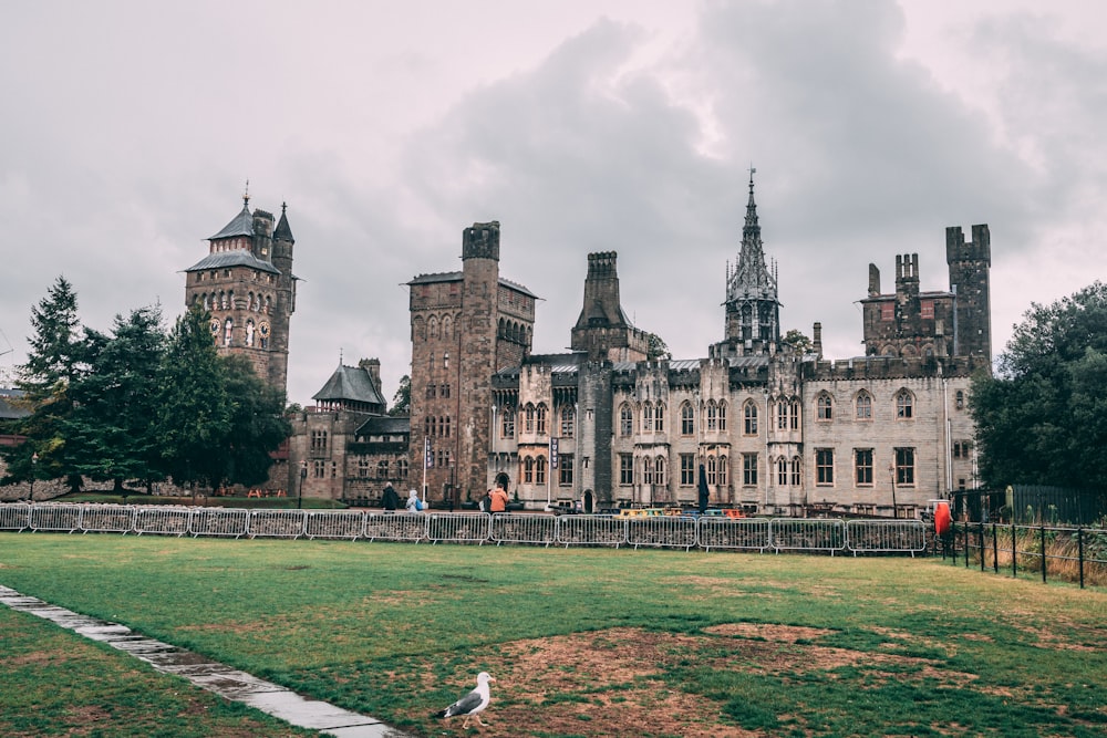 a large building with towers and a bird in front of it