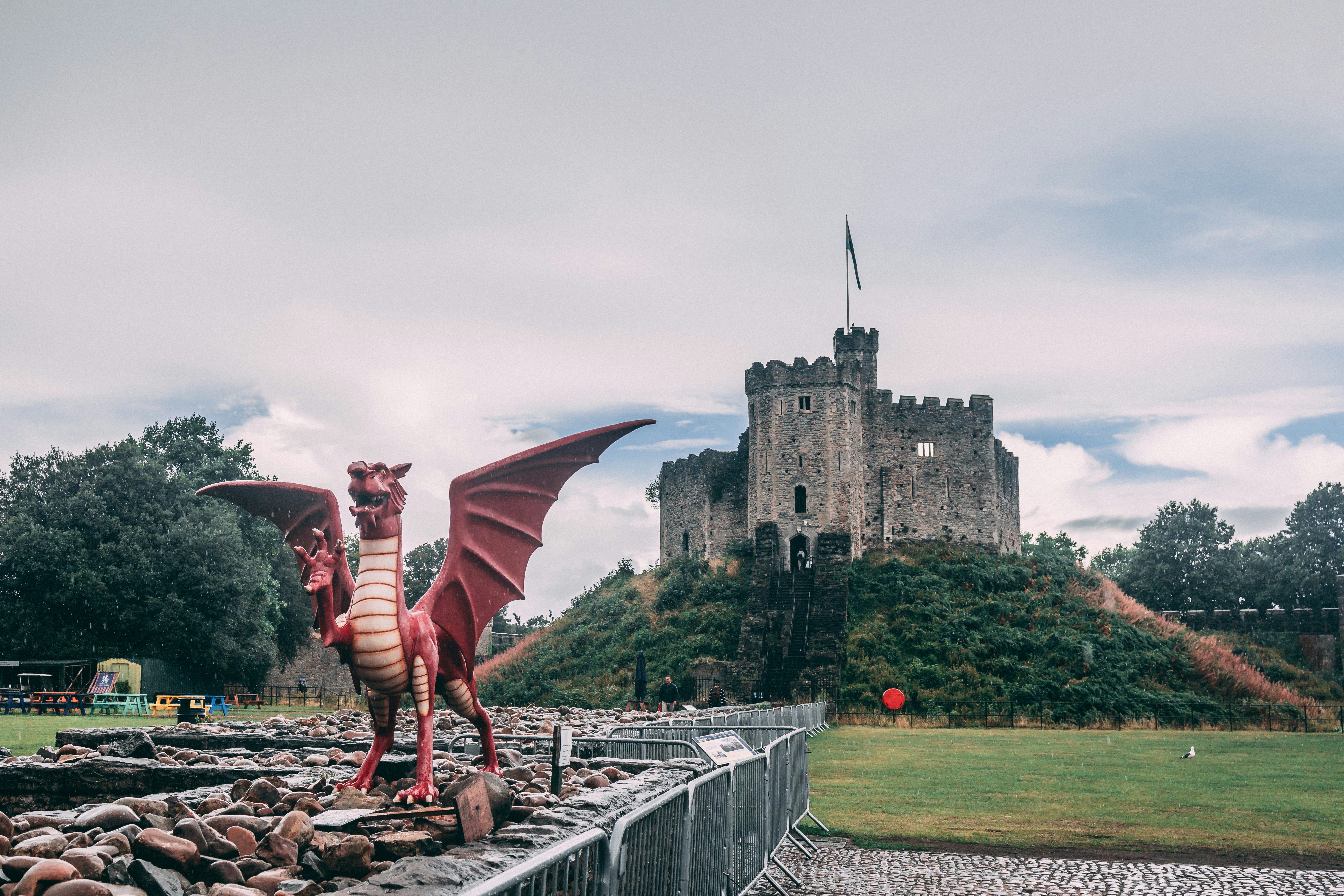 a statue of a person with wings and a cape on a bridge