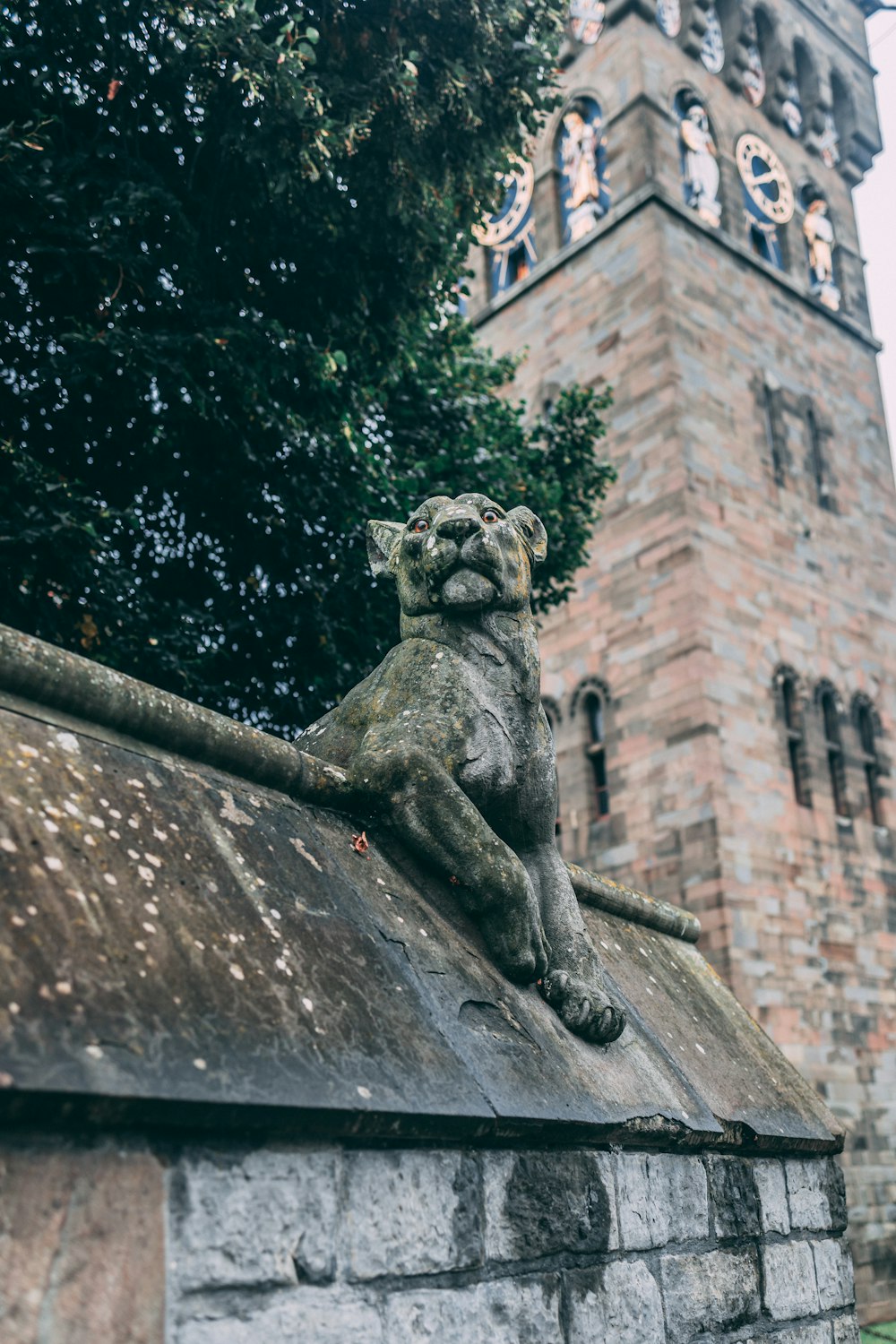 a statue of a cat on a stone wall