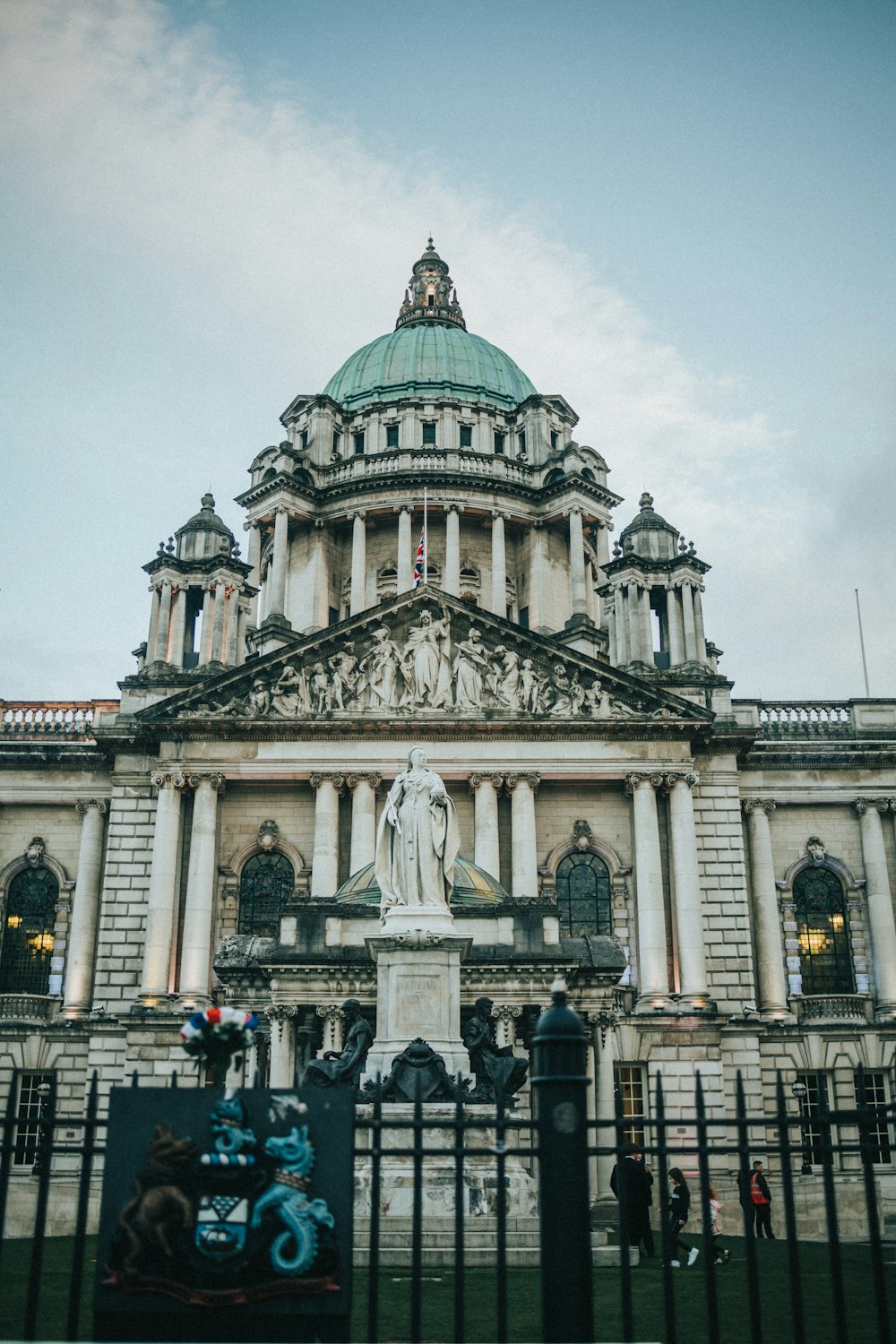 a large white building with a statue in front of it