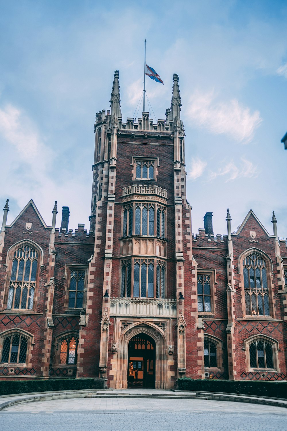 a large brick building with a flag on top