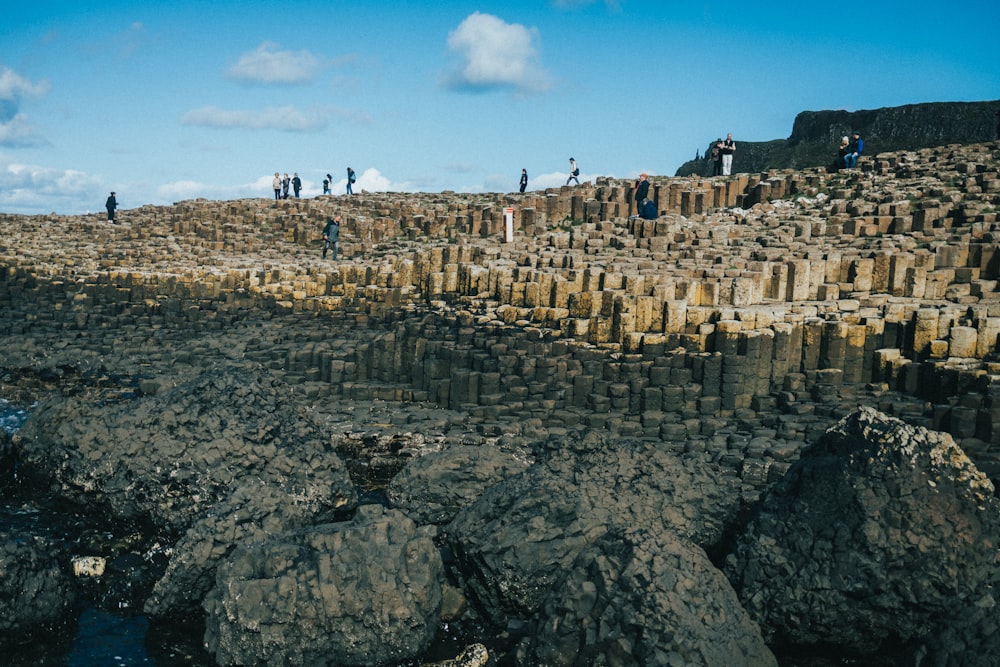 a group of people standing on a rock wall