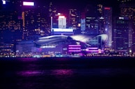 Dynamic cityscape at night with neon green and purple lighting reflecting modernity and growth.