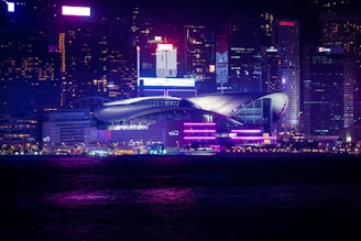 Dynamic cityscape at night with neon green and purple lighting reflecting modernity and growth.