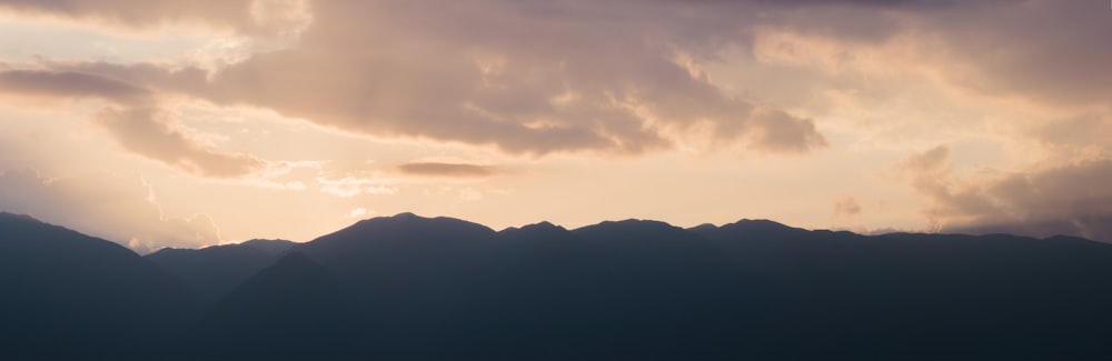 a landscape with hills and clouds