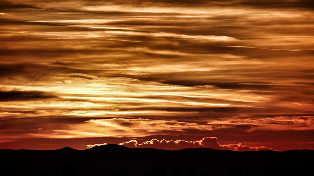 a sunset over a mountain range