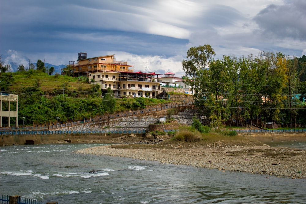 a body of water with a bridge and buildings in the background